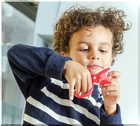 Teaching a child to cut with scissors